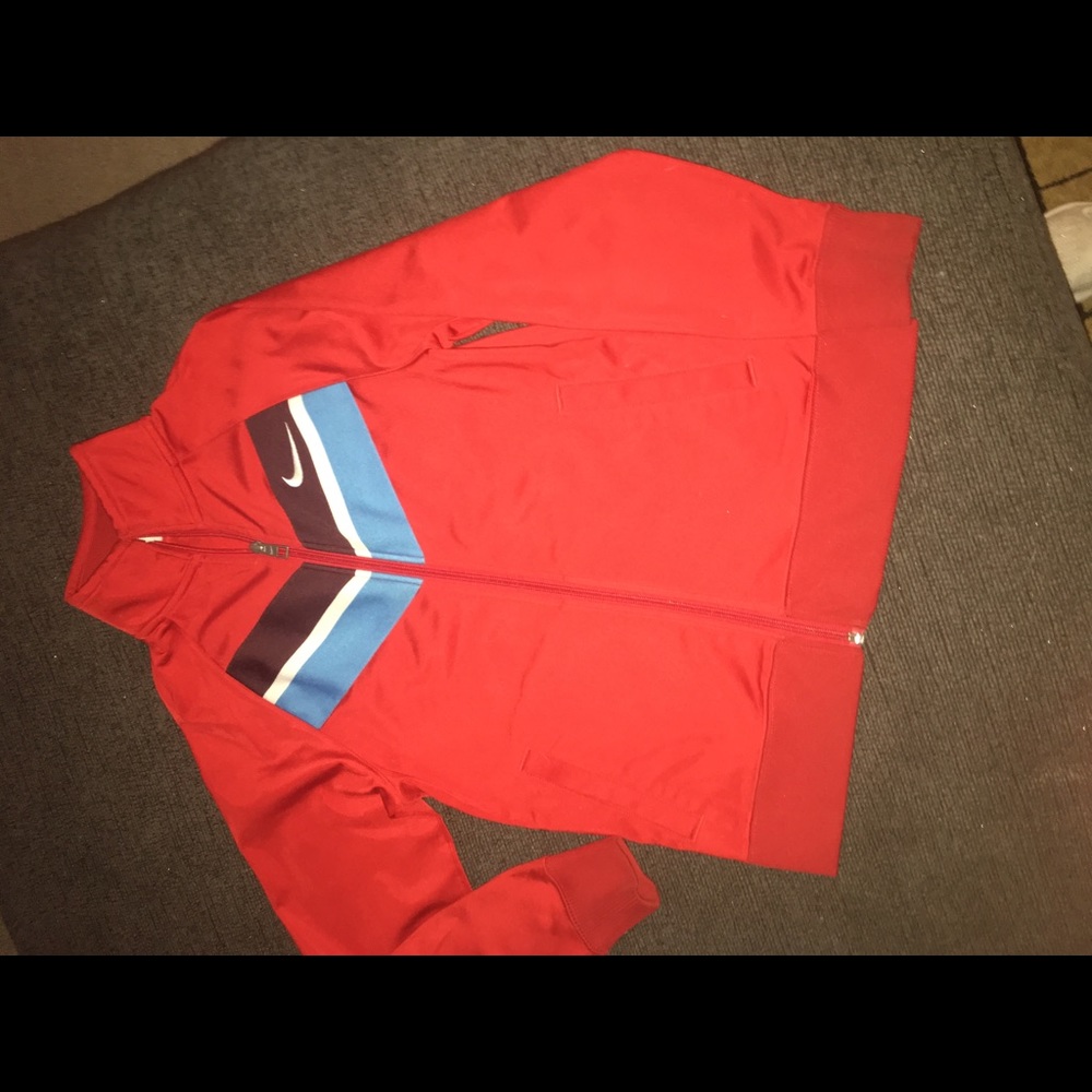 Nike jacket. Size M/10/12. Red with plum,white and blue stripe on front.